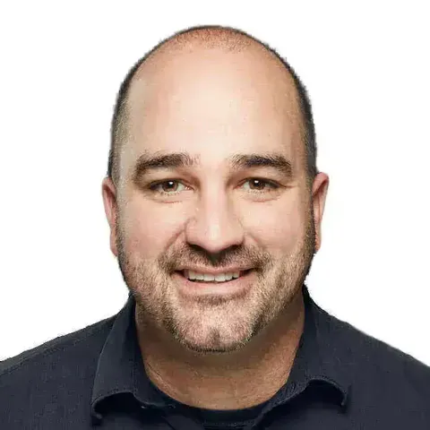 Griffin Stewart, smiling, in a dark button-up shirt