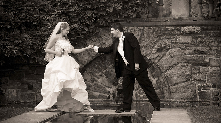 Bride and groom at a stone archway